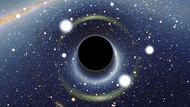 A simulated view of a black hole. It is a round, dark object, and it distorts the light that travels nearby it, making it appear to 'warp' the space around it.