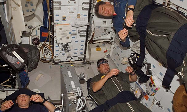 Astronauts in their sleeping bags.