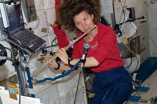 Astronaut Cady Coleman playing a flute on board the International Space Station.