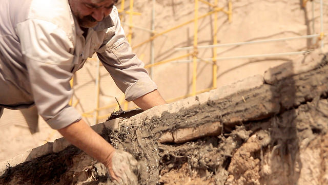 A man reconstructing an ancient mud brick citadel in Iran after it was damaged in an earthquake.