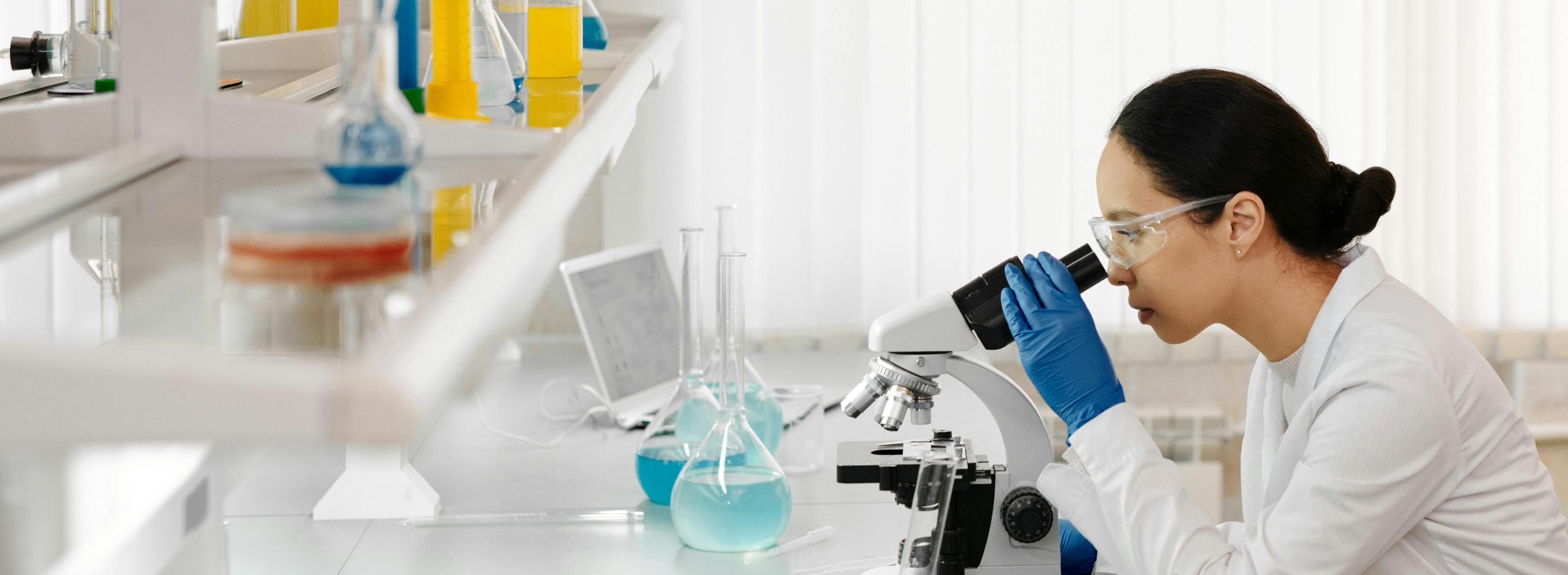 Female scientist looking through a microscope