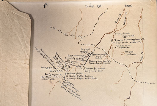 A close-up of a hand-drawn geological map on a piece of yellowing paper