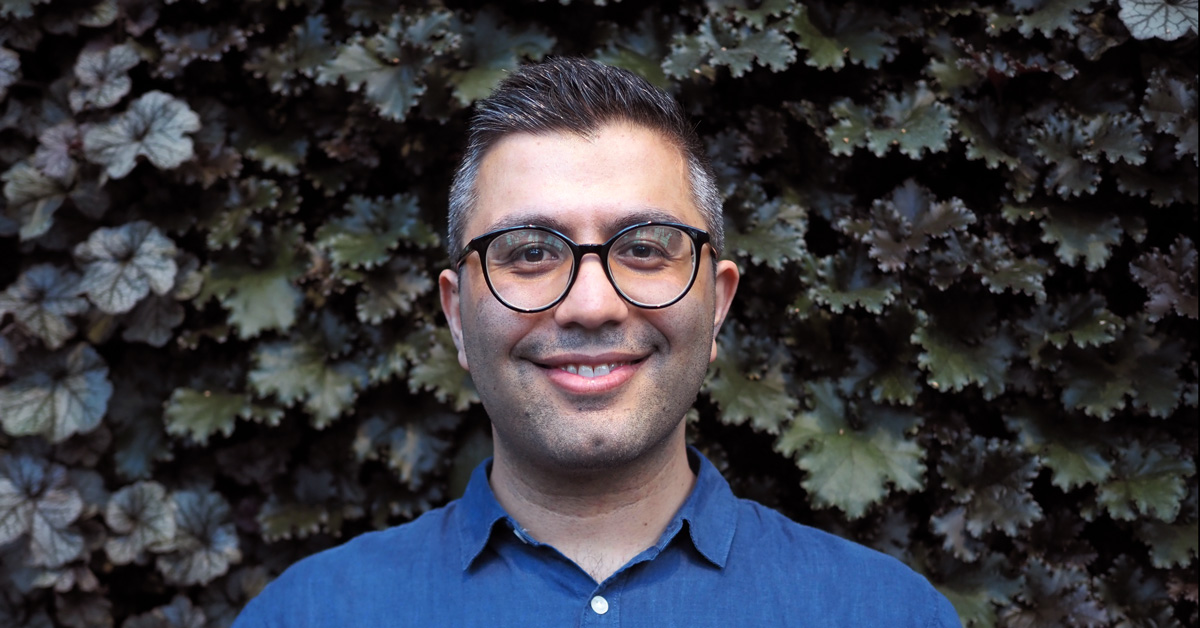 Man wearing glasses smiling at camera