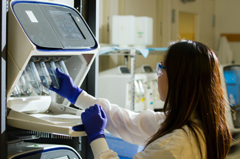 Image of woman attaching a test tube. Photo by National Cancer Institute on Unsplash